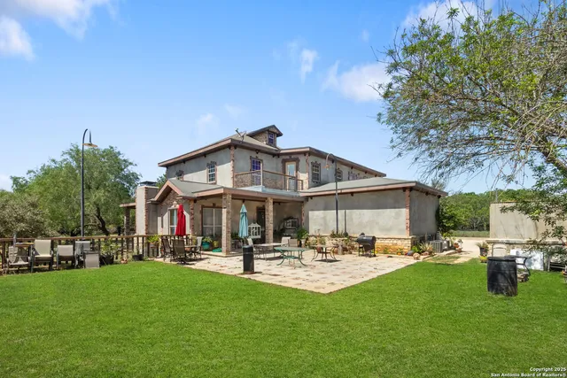 a view of a patio with table and chairs under an umbrella