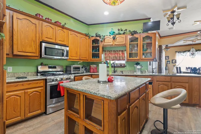 a kitchen with stainless steel appliances granite countertop a sink and a wooden cabinets