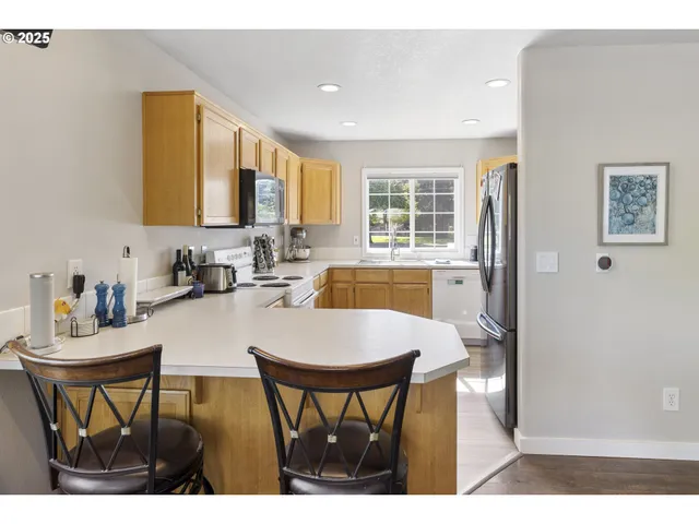 a kitchen with a sink a window and cabinets
