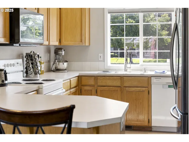 a kitchen with refrigerator cabinets and a sink