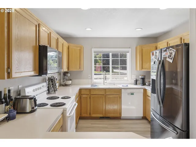 a kitchen with a sink stove and refrigerator