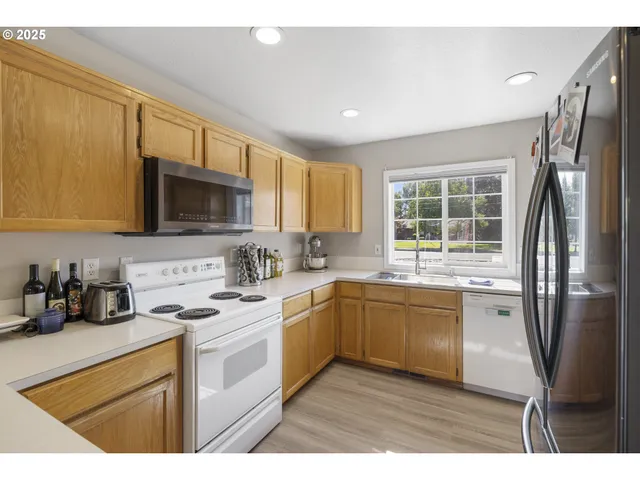 a kitchen with a sink a refrigerator and window