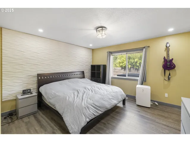 a bedroom with a bed and a desk