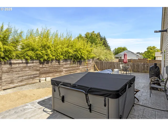 a backyard of a house with table and chairs