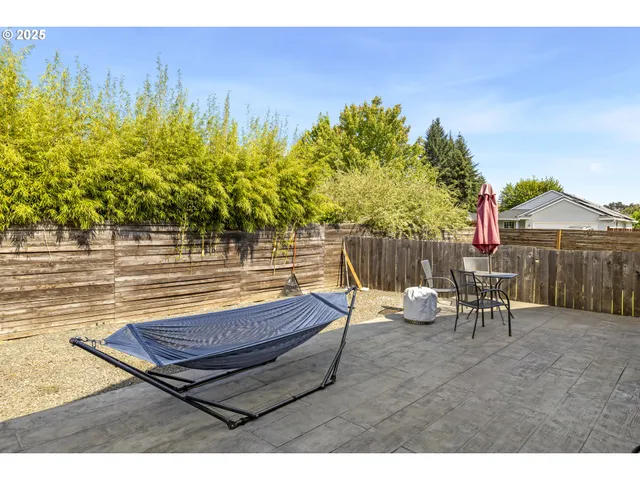 a view of a backyard with a table and chair