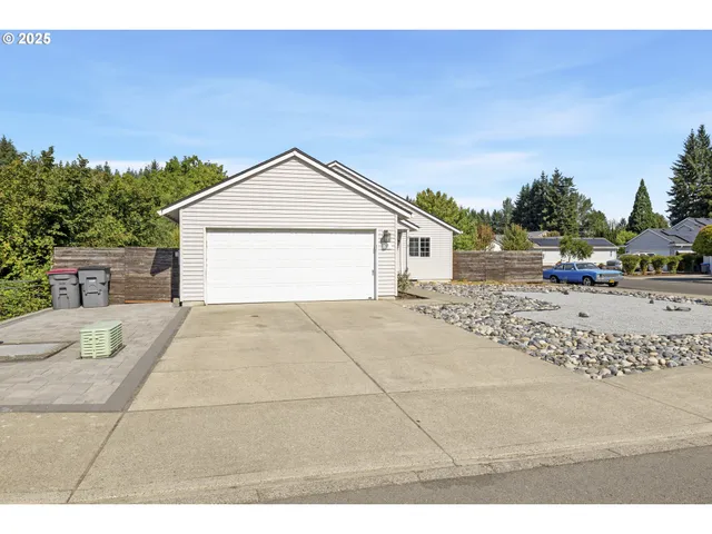 a view of house with backyard and lake