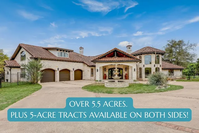 a living room with fireplace furniture and a large window