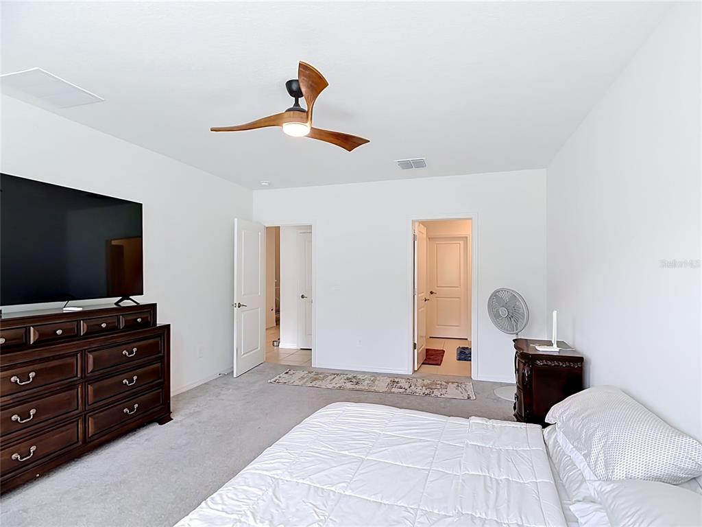 1633 Red Loop Lakeland, FL 33801 - Photo 24 of 60 a bedroom with a bed and a flat screen tv