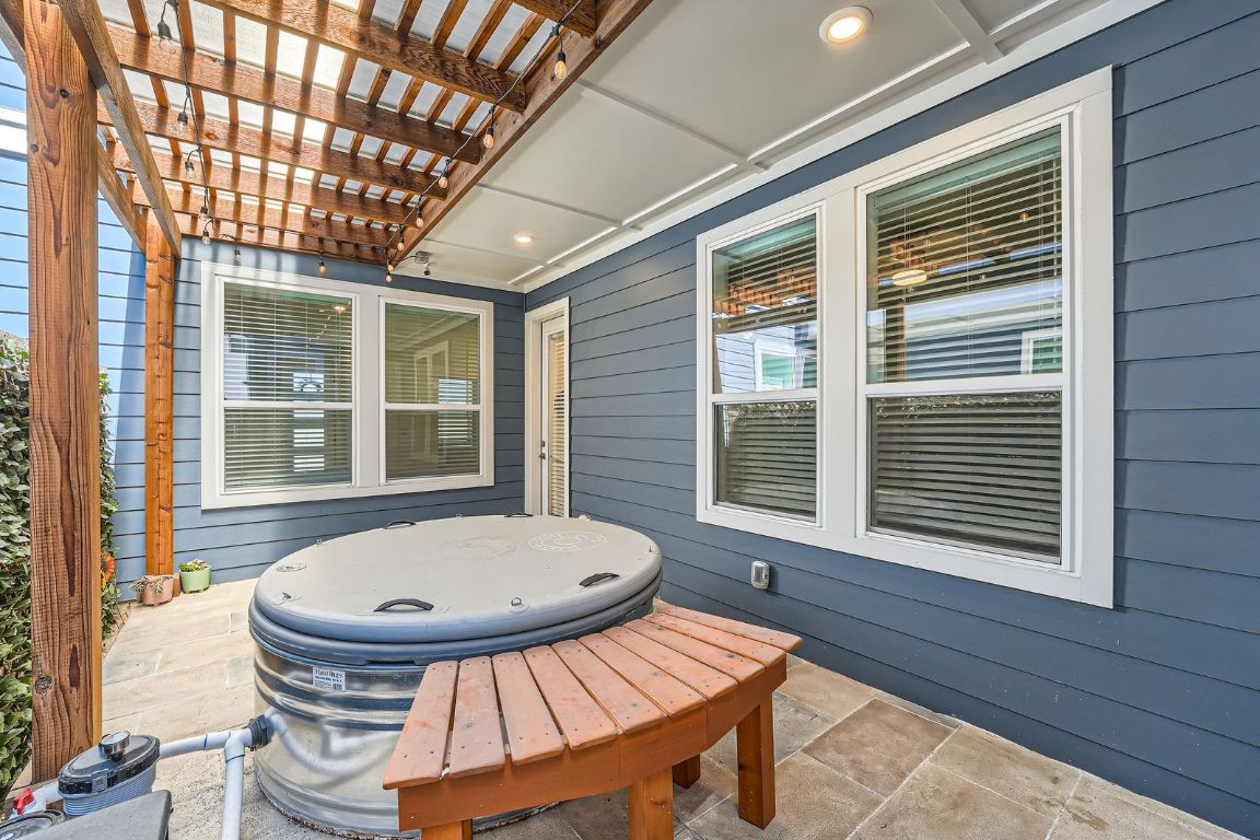 3213 Zach Scott Street Austin, TX 78723 - Photo 26 of 28 View of patio featuring an outdoor hot tub and a pergola With custom bench.