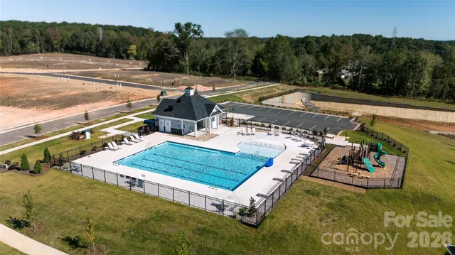 a view of a swimming pool with a yard
