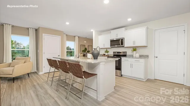 a kitchen with a sink cabinets and wooden floor