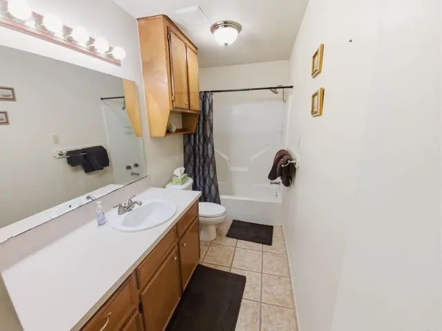 a bathroom with a sink a mirror and shower