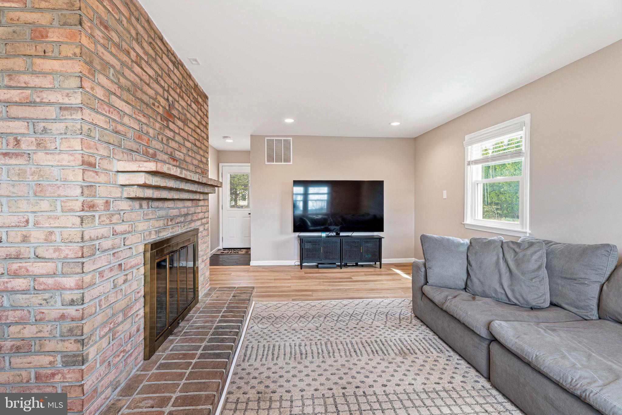 1211 Grafton Shop Road Bel Air, MD 21014 - Photo 18 of 42 a living room with furniture a flat screen tv and a fireplace