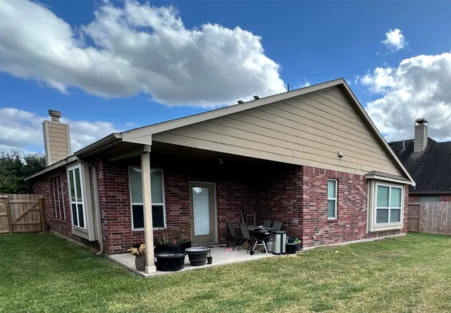 a view of a house with a yard and deck