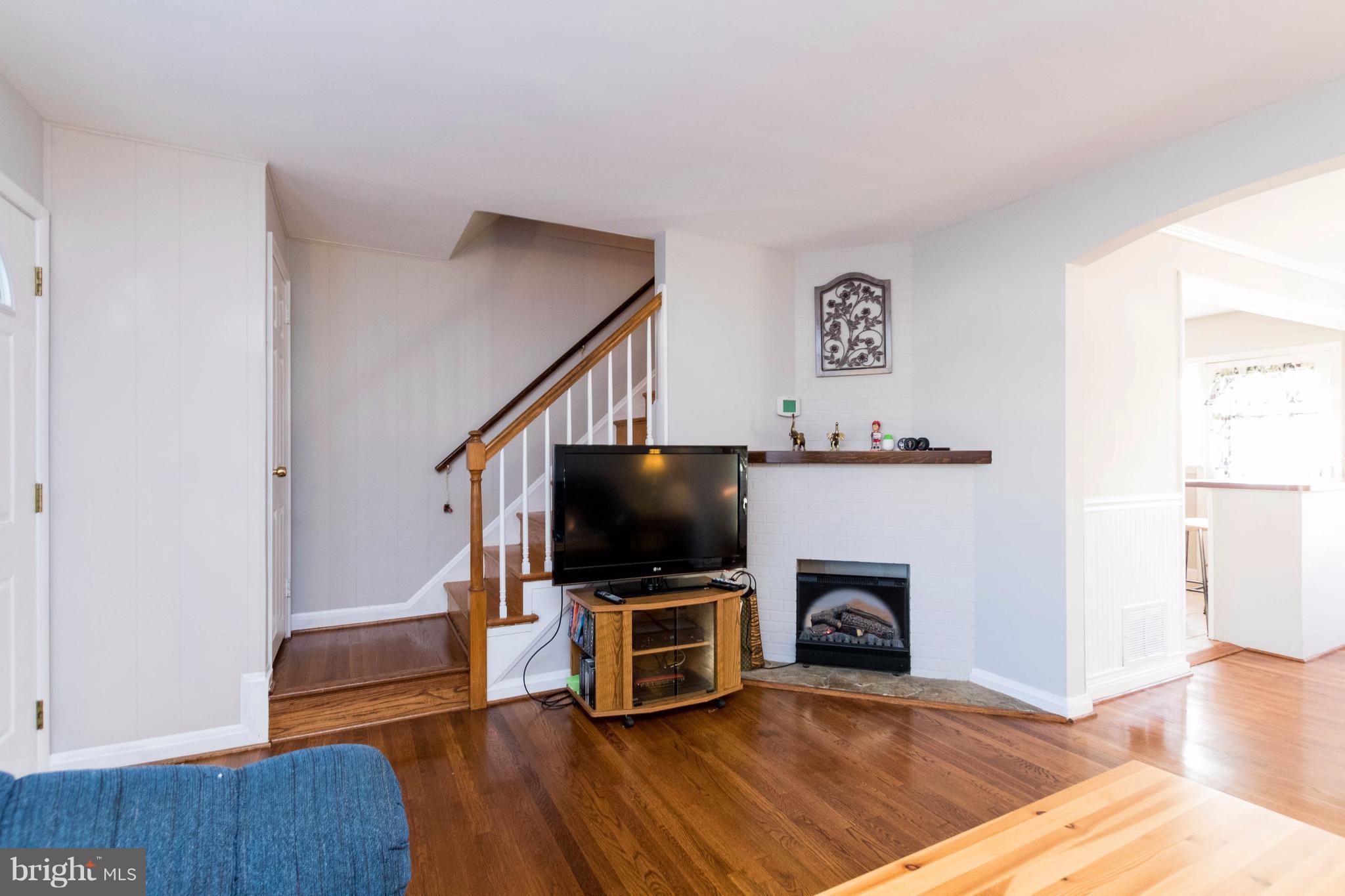 2016 Ormand Road Baltimore, MD 21222 - Photo 9 of 26 a living room with furniture a flat screen tv and a fireplace