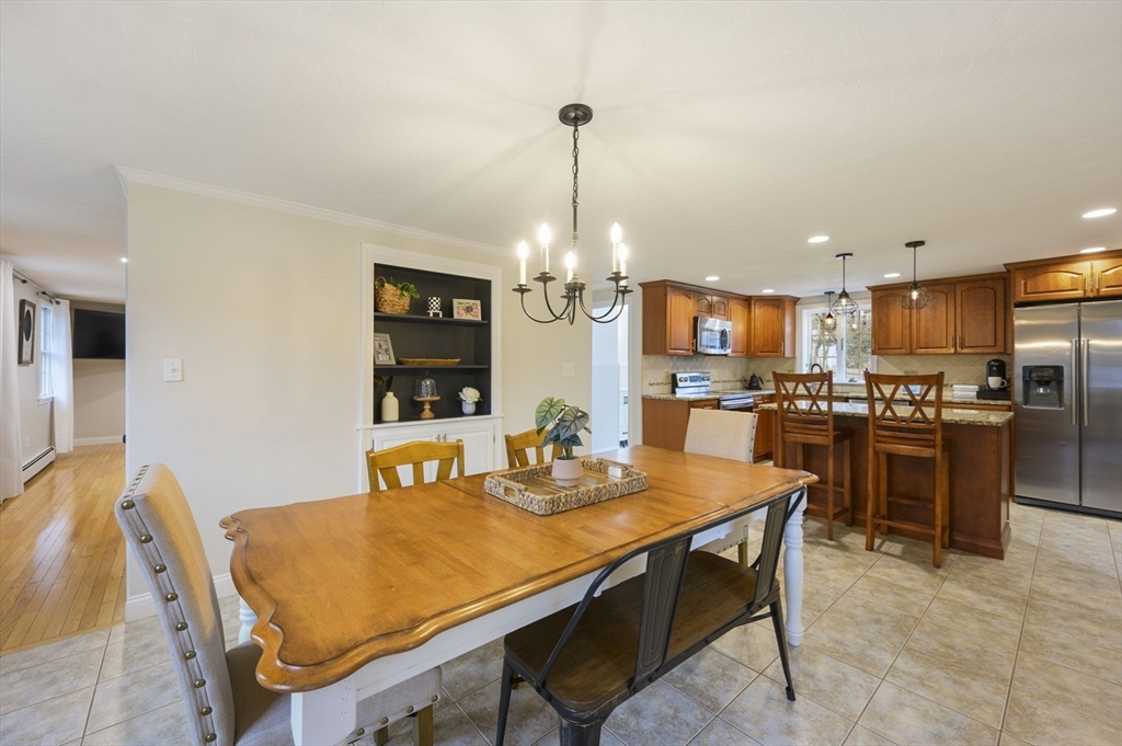 31 Indian Trail Hanson, MA 02341 - Photo 12 of 41 a kitchen with a dining table chairs and refrigerator