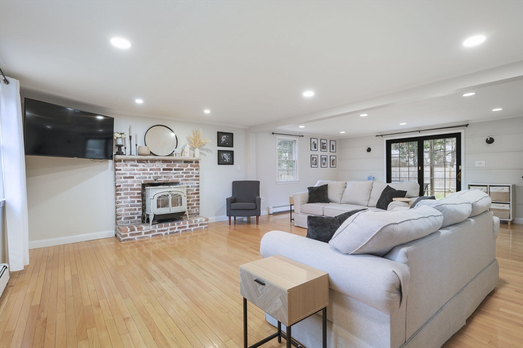 31 Indian Trail Hanson, MA 02341 - Photo 16 of 41 a living room with furniture a fireplace and wooden floor