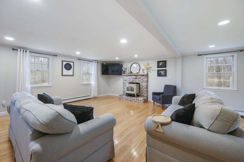 31 Indian Trail Hanson, MA 02341 - Photo 17 of 41 a living room with furniture and a fireplace