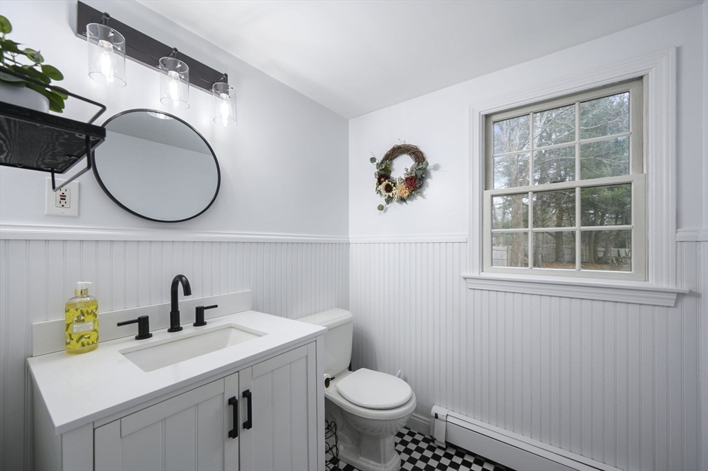 31 Indian Trail Hanson, MA 02341 - Photo 21 of 41 a bathroom with a toilet a sink and mirror