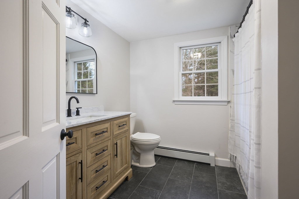 31 Indian Trail Hanson, MA 02341 - Photo 24 of 41 a bathroom with a toilet sink and mirror