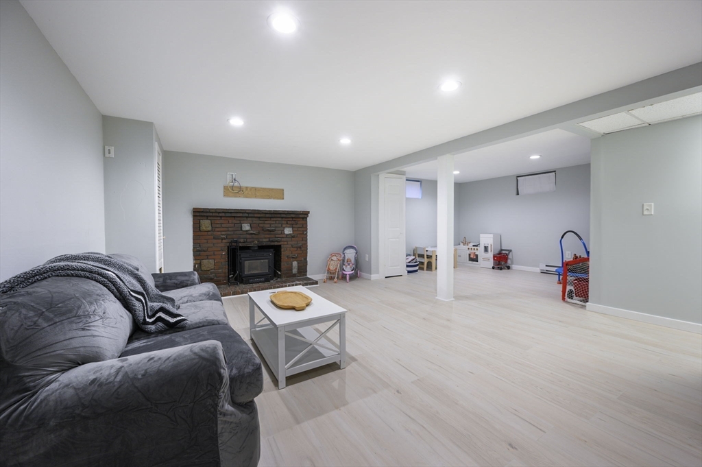 31 Indian Trail Hanson, MA 02341 - Photo 28 of 41 a living room with furniture and a fireplace