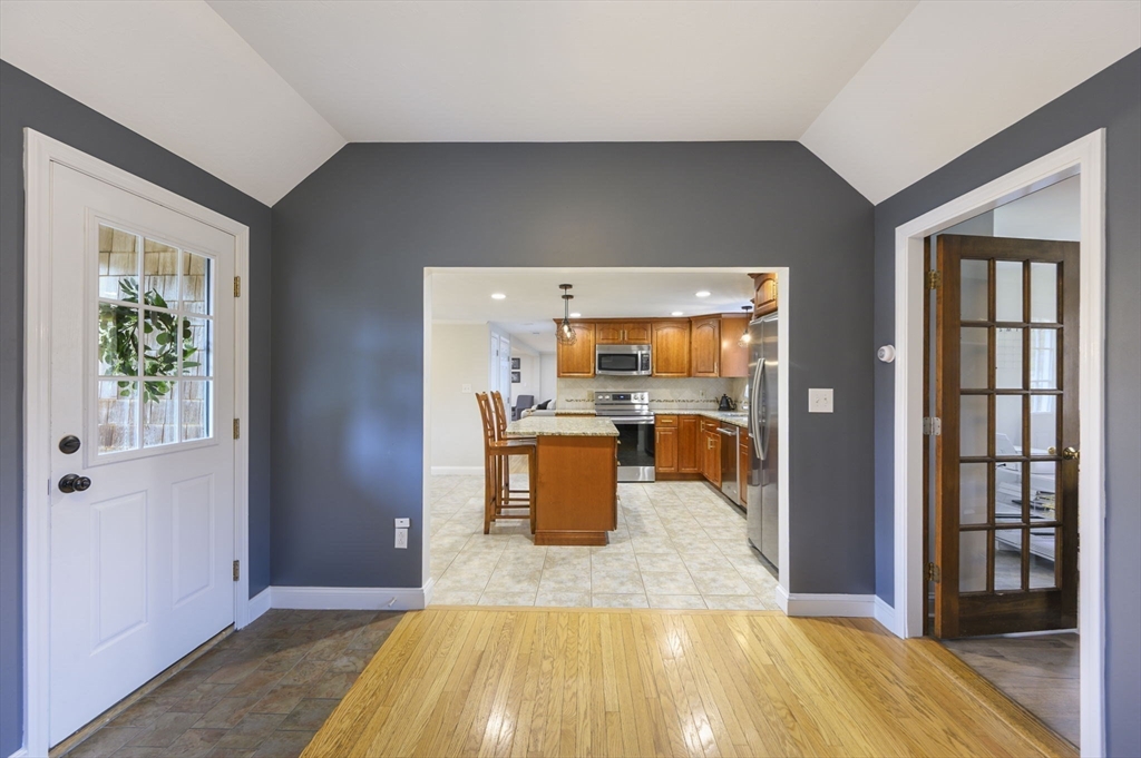 31 Indian Trail Hanson, MA 02341 - Photo 4 of 41 a room with wooden floor and a kitchen