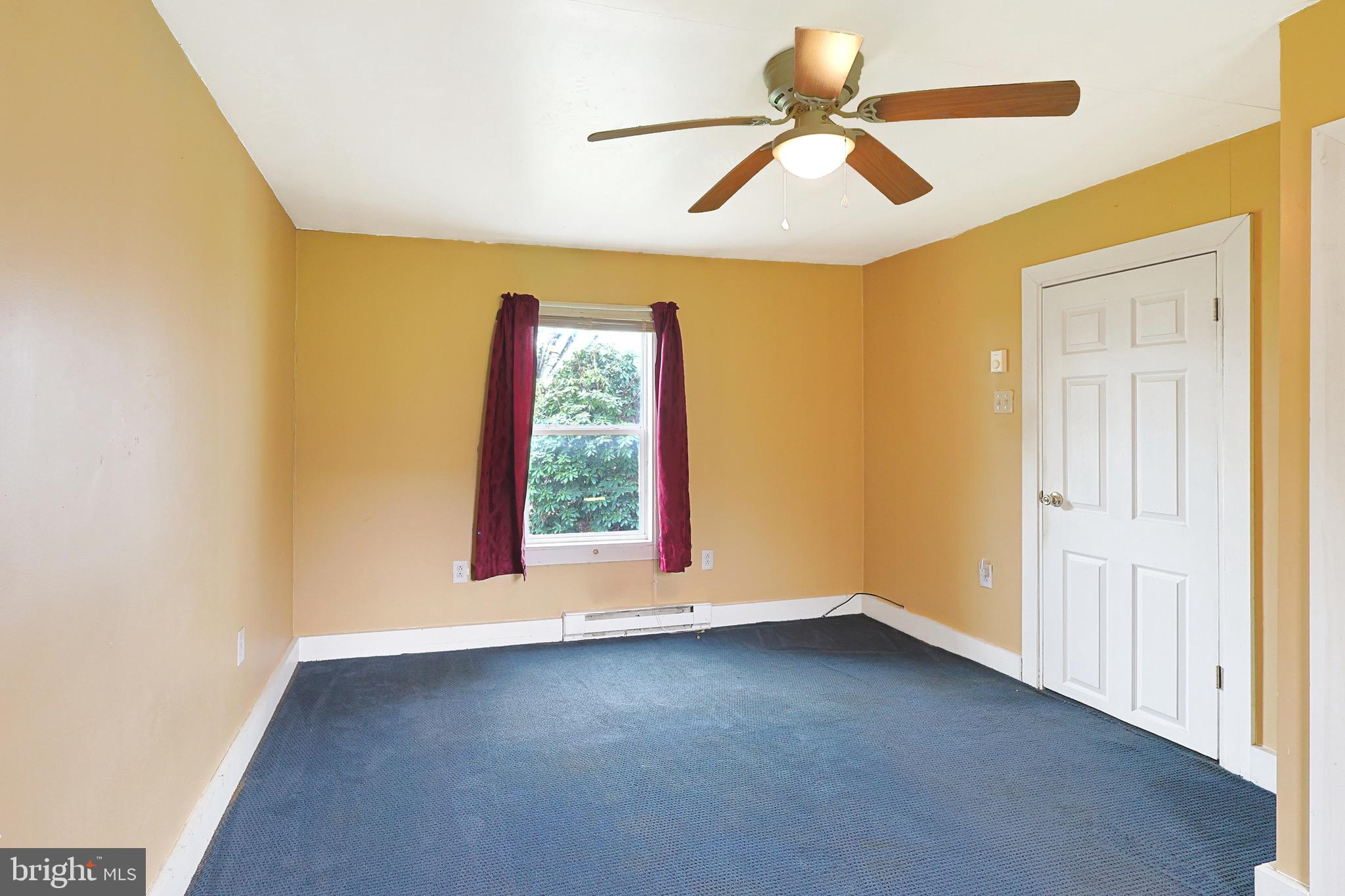 715 Charles Street Romney, WV 26757 - Photo 22 of 44 an empty room with windows and fan