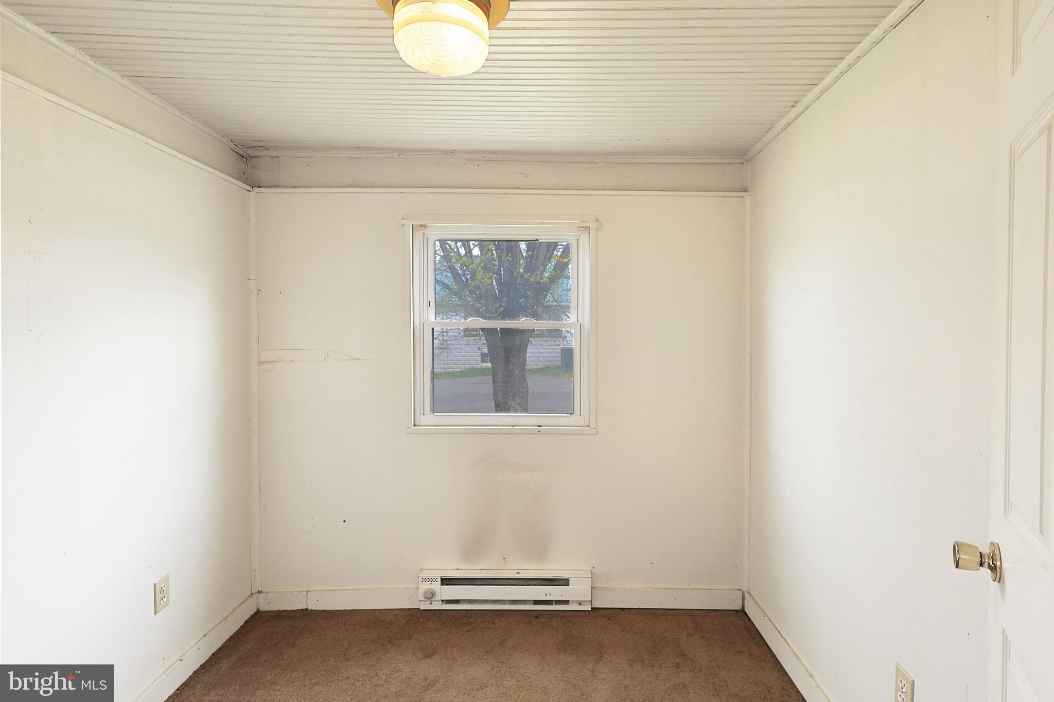 715 Charles Street Romney, WV 26757 - Photo 32 of 44 a view of a room with wooden floor and a window