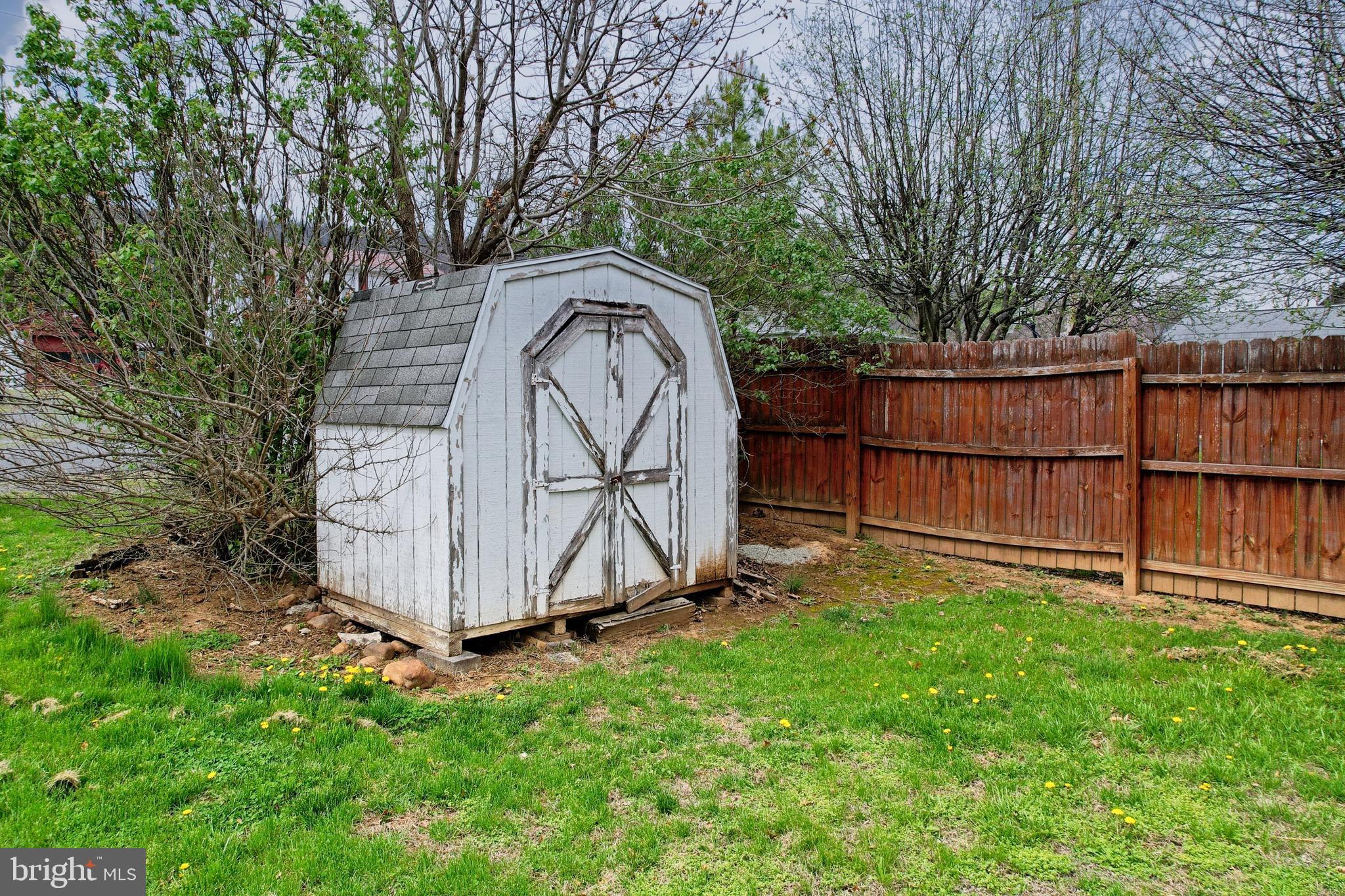 715 Charles Street Romney, WV 26757 - Photo 5 of 44 a view of backyard with wooden fence and large trees