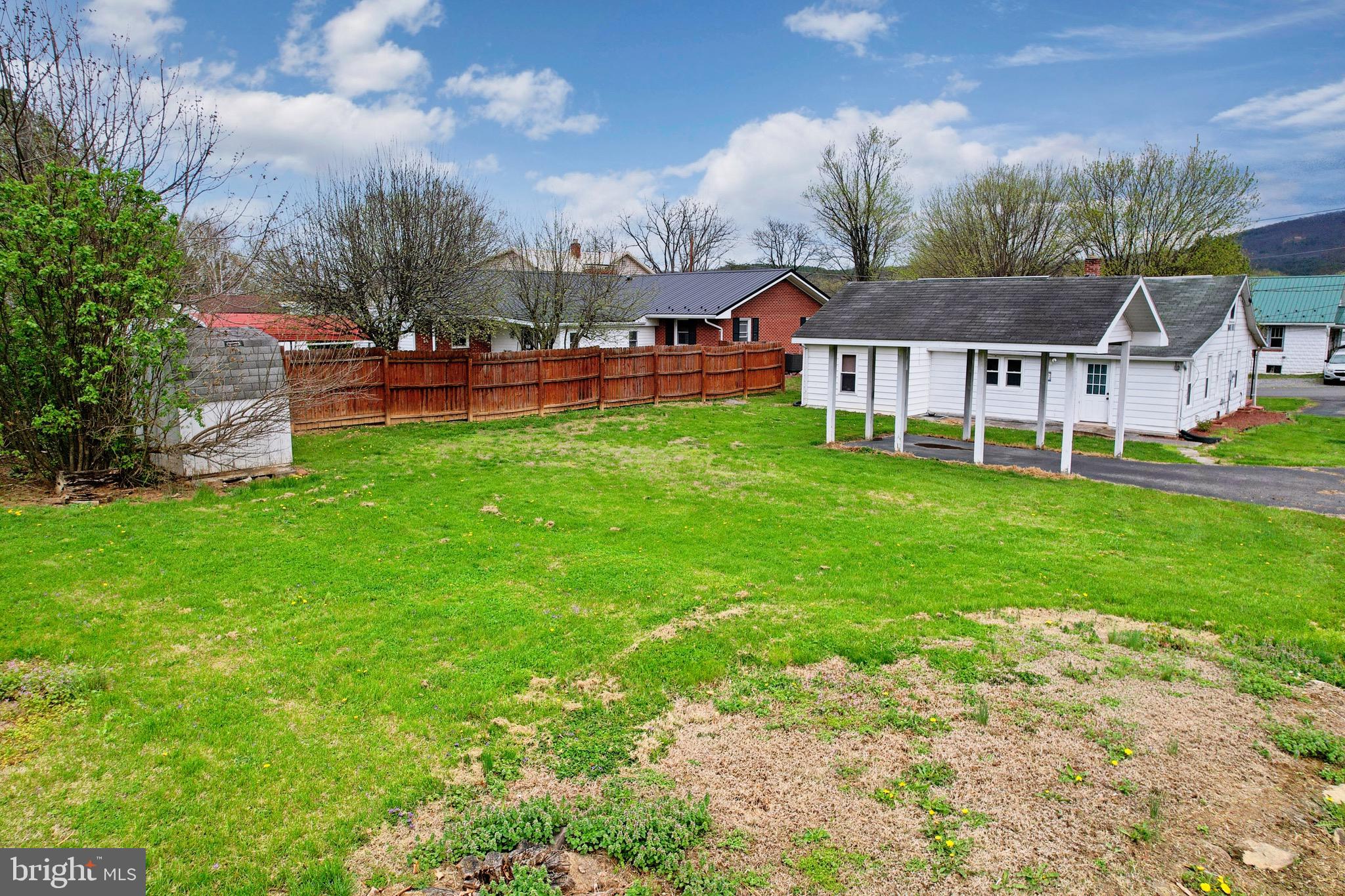 715 Charles Street Romney, WV 26757 - Photo 6 of 44 a view of a house with a big yard and large trees