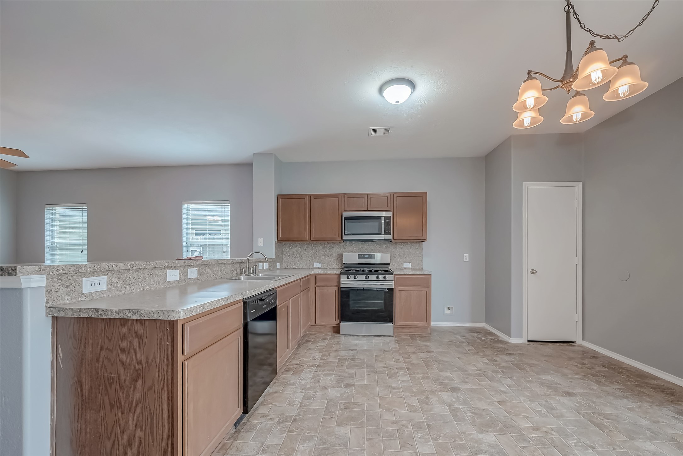 6211 Borage Street Crosby, TX 77532 - Photo 21 of 43 a kitchen with kitchen island granite countertop a sink and stove