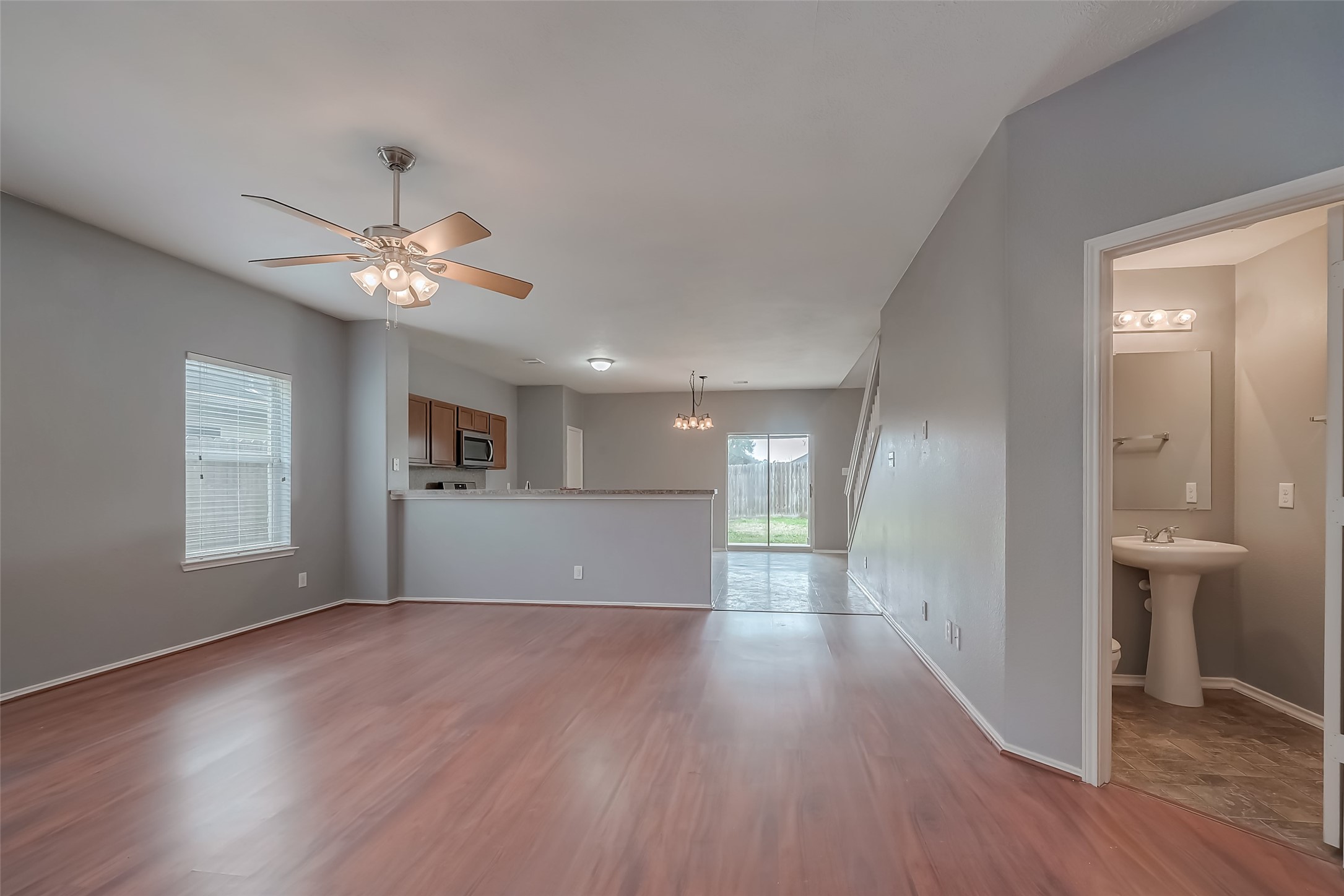 6211 Borage Street Crosby, TX 77532 - Photo 10 of 43 a view of an empty room with a window and wooden floor