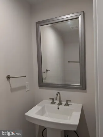 wooden floor in an empty room with a chandelier