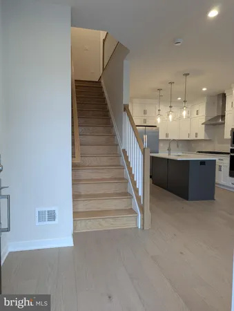 a view of a kitchen with furniture and staircase