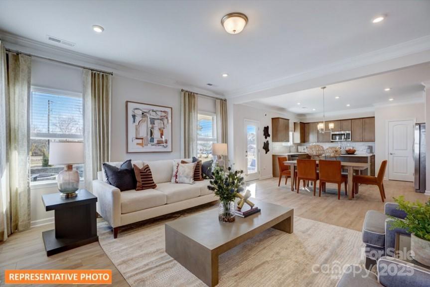 6416 Busch Way Locust, NC 28097 - Photo 11 of 25 a living room with furniture potted plant kitchen view and a window
