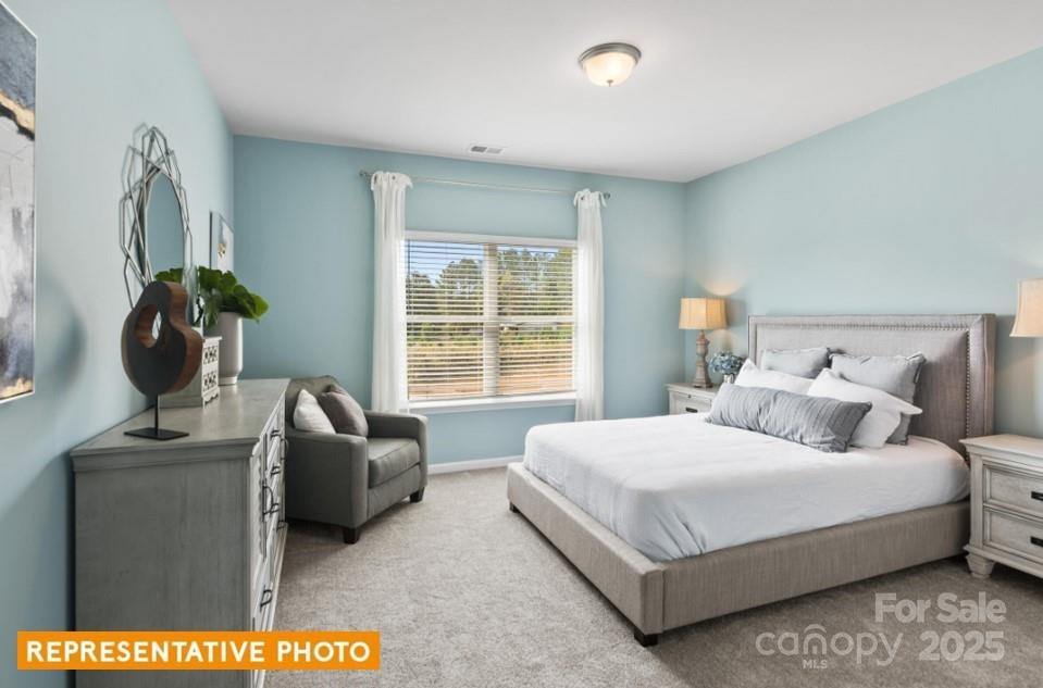 6416 Busch Way Locust, NC 28097 - Photo 19 of 25 a bedroom with a bed and window