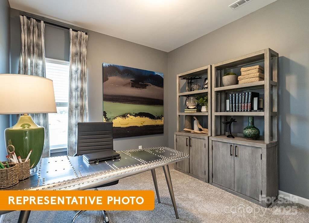 6416 Busch Way Locust, NC 28097 - Photo 6 of 25 a living room with furniture and a book shelf