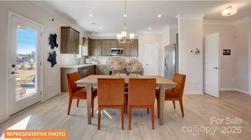 6416 Busch Way Locust, NC 28097 - Photo 7 of 25 a view of a dining room with furniture and wooden floor