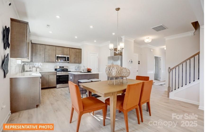 6416 Busch Way Locust, NC 28097 - Photo 8 of 25 a large kitchen with a table and chairs
