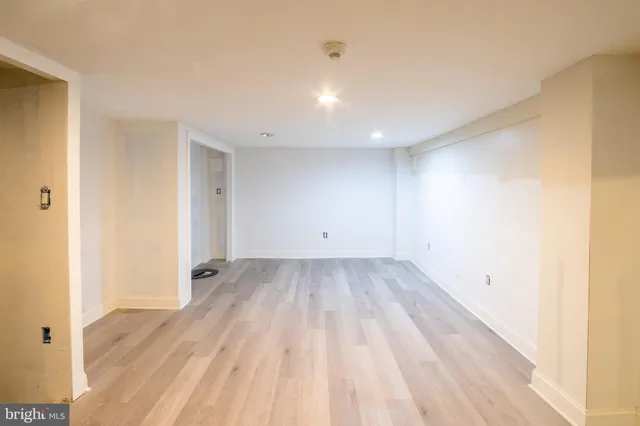 a view of a room with wooden floor