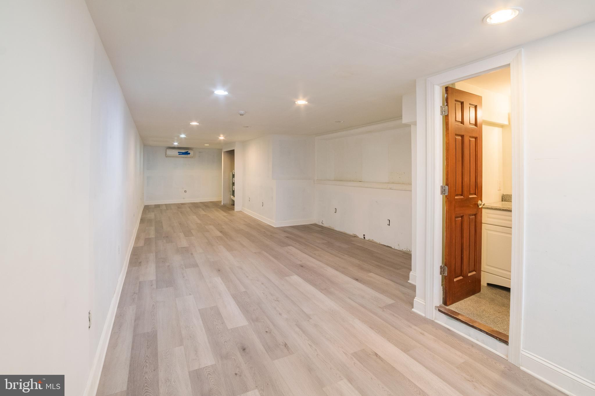 2504 South Broad Street, Unit COMMERCIAL Philadelphia, PA 19145 - Photo 7 of 11 an empty room with wooden floor and entrance