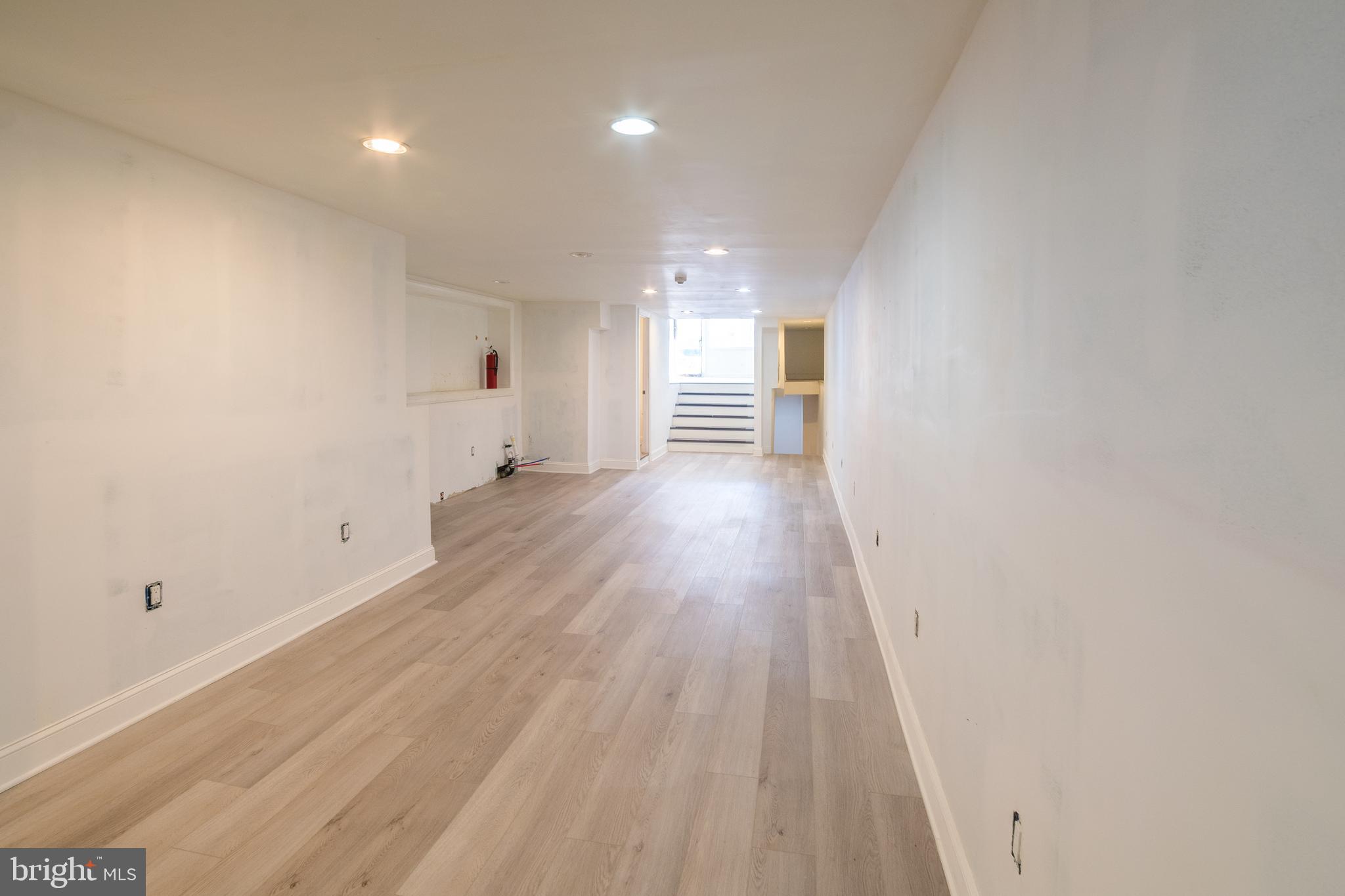 2504 South Broad Street, Unit COMMERCIAL Philadelphia, PA 19145 - Photo 8 of 11 a view of an empty room with wooden floor and a window