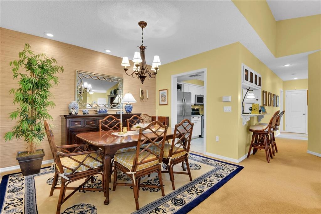 780 Willowbrook Drive, Unit 707 Naples, FL 34108 - Photo 12 of 36 a view of a dining room with furniture