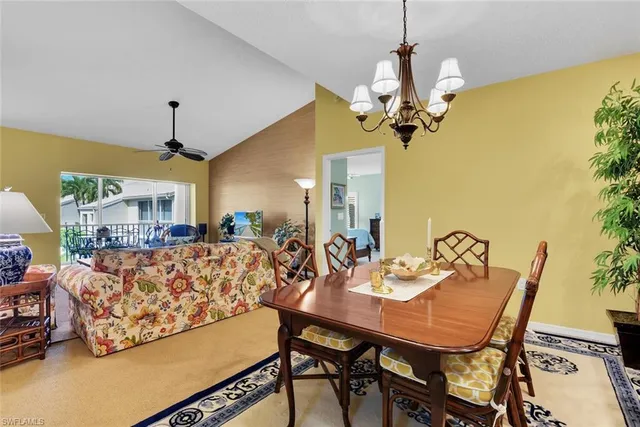 a view of a dining room with furniture and a chandelier