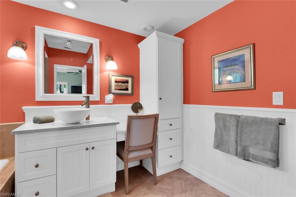 780 Willowbrook Drive, Unit 707 Naples, FL 34108 - Photo 18 of 36 a bathroom with a sink mirror and a vanity