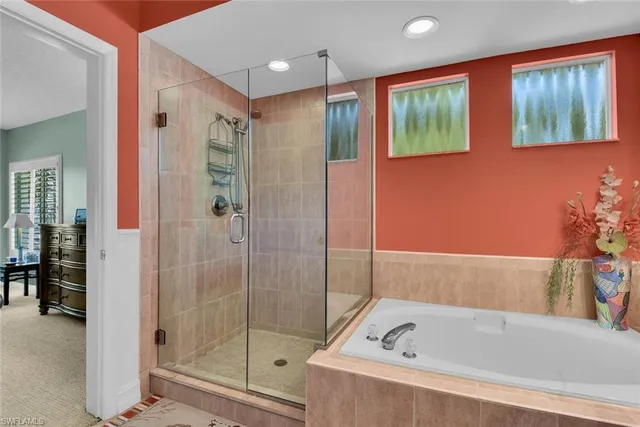 a bathroom with a bathtub and a shower