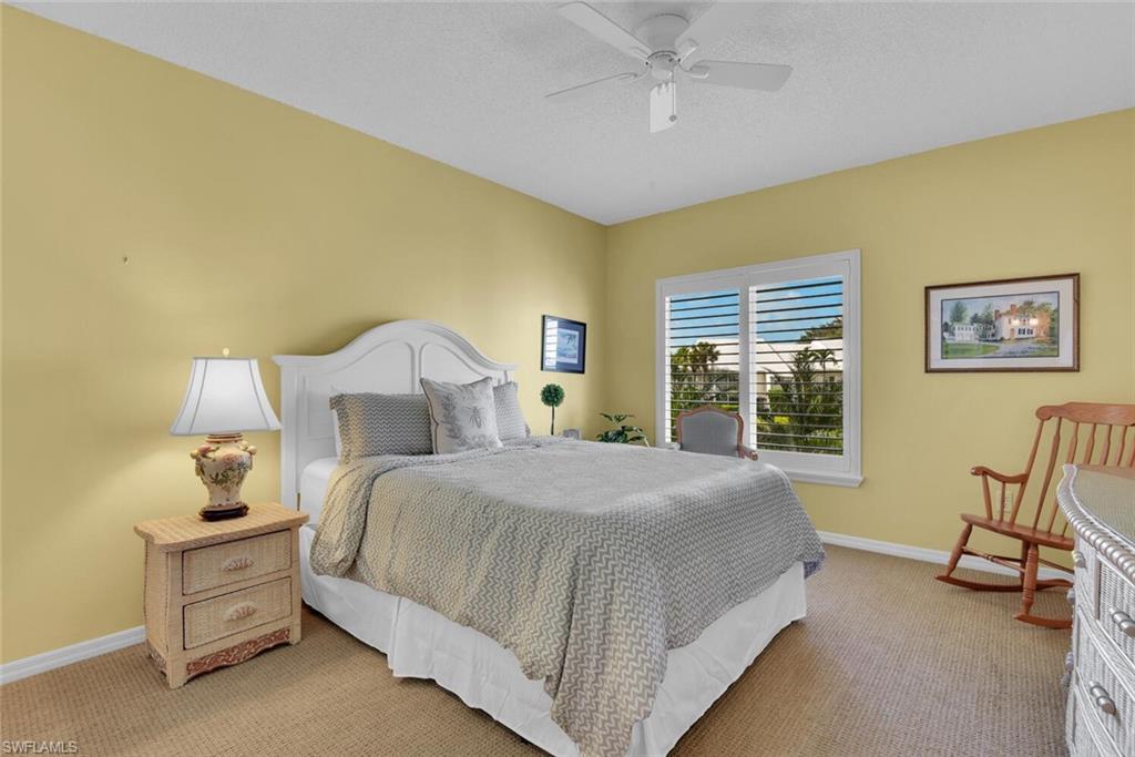 780 Willowbrook Drive, Unit 707 Naples, FL 34108 - Photo 22 of 36 a bedroom with a bed chair and window