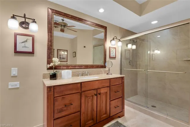a bathroom with a shower sink and mirror