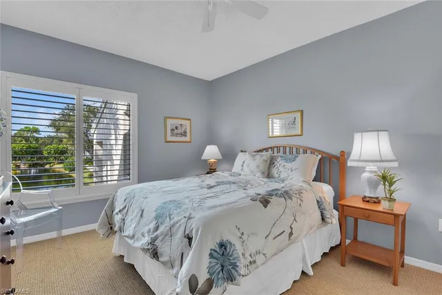 a bedroom with a large bed and a lamp on table