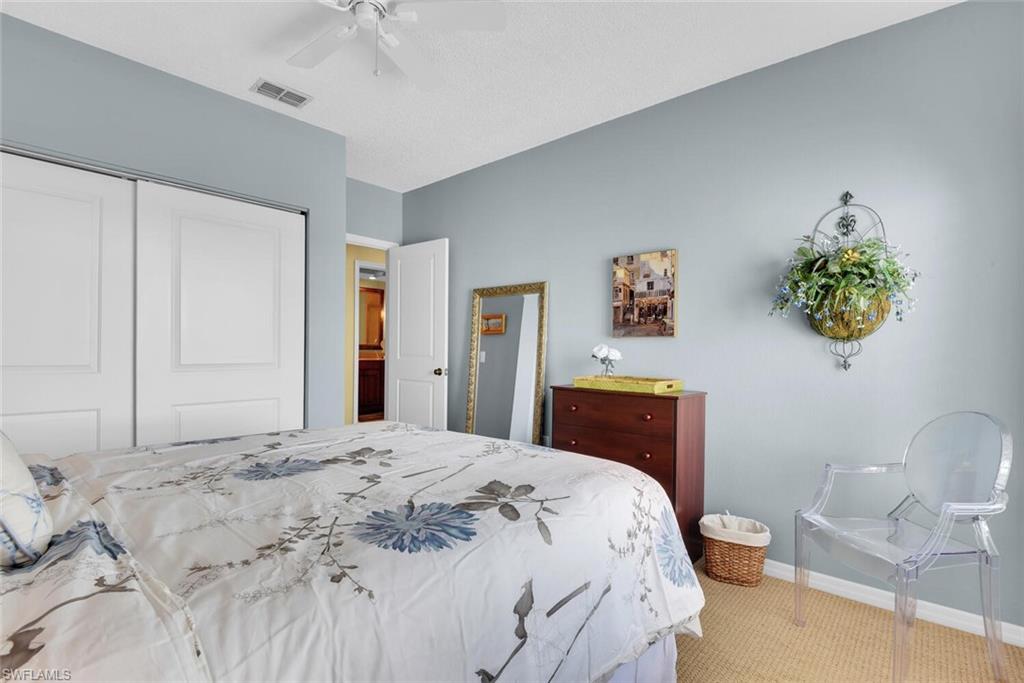 780 Willowbrook Drive, Unit 707 Naples, FL 34108 - Photo 26 of 36 a bedroom with a bed and a dresser